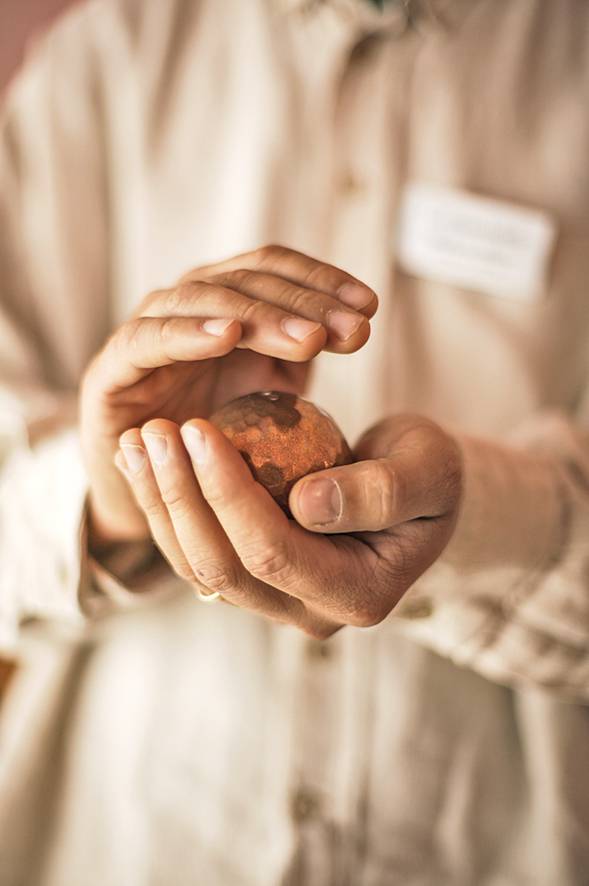 Hände halten Kugel beschützt